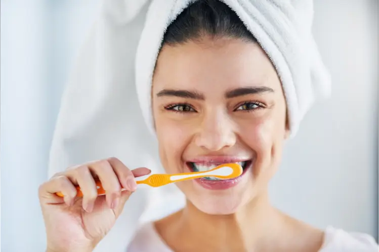 A woman brushing her teeth